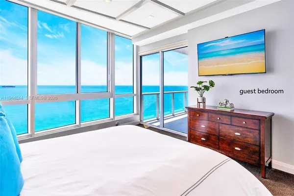 a bedroom with a bed and a large window
