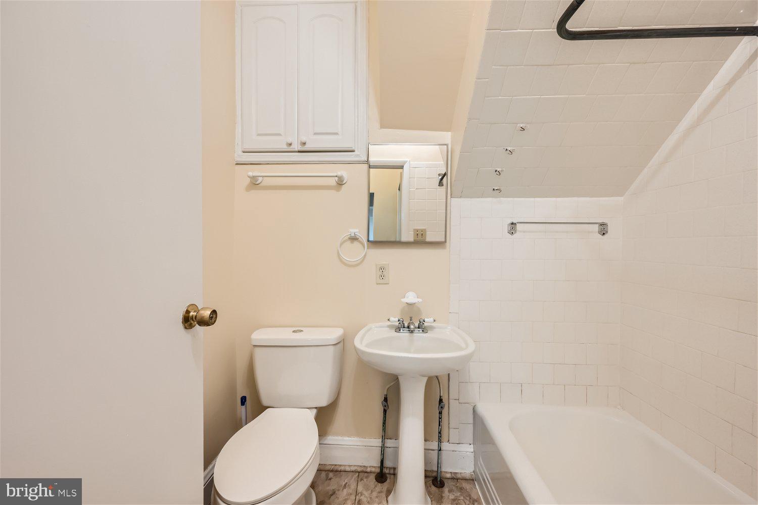 716 South Camp Meade Road, Unit A Linthicum Heights, MD 21090 - Photo 8 of 11 a bathroom with a sink a toilet and bathtub