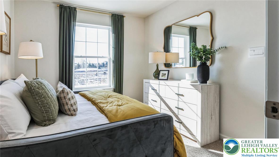 8344 Alexander Court Breinigsville, PA 18031 - Photo 22 of 25 a bedroom with a bed a mirror and a window