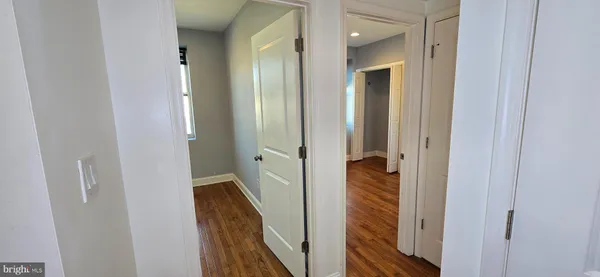 a view of a hallway with the wooden floor