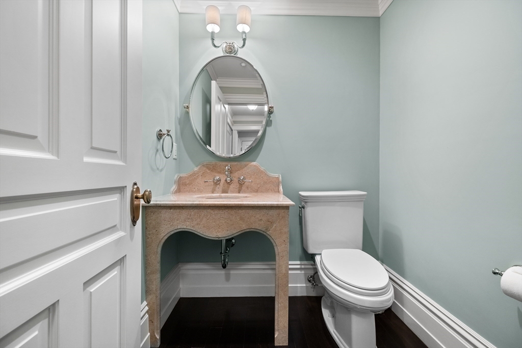 45 Commonwealth Avenue, Unit 4 Boston, MA 02116 - Photo 22 of 25 a bathroom with a toilet a sink and a mirror