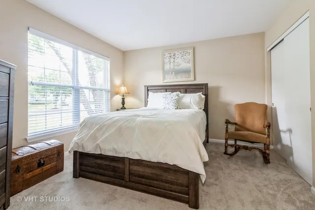 a bed room with a bed and a chair