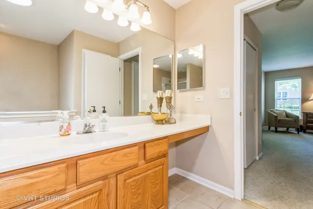 a en suite bathroom with a sink double vanity and a mirror