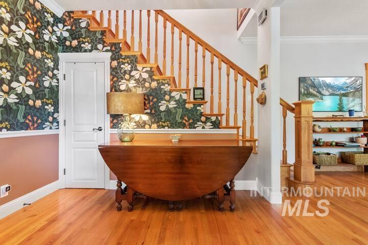 1617 North 5th Street Boise, ID 83702 - Photo 11 of 36 Bar with crown molding, light wood-style flooring, wallpapered walls, and stairs