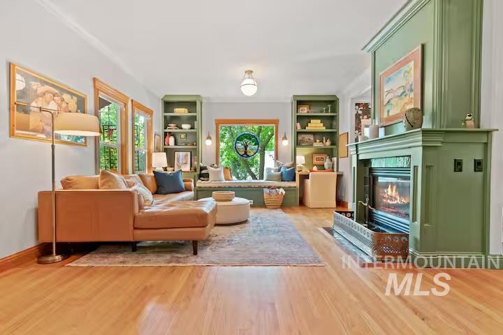 1617 North 5th Street Boise, ID 83702 - Photo 5 of 36 Living room with built in features, a glass covered fireplace, and light wood-style flooring