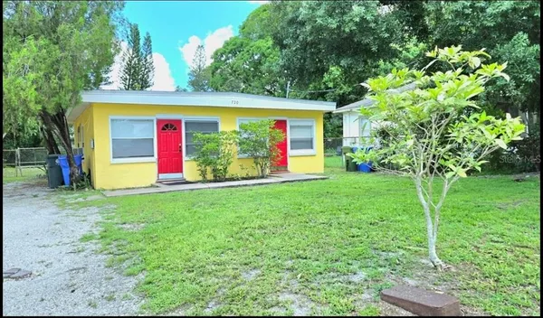 a view of a house with a backyard and garden