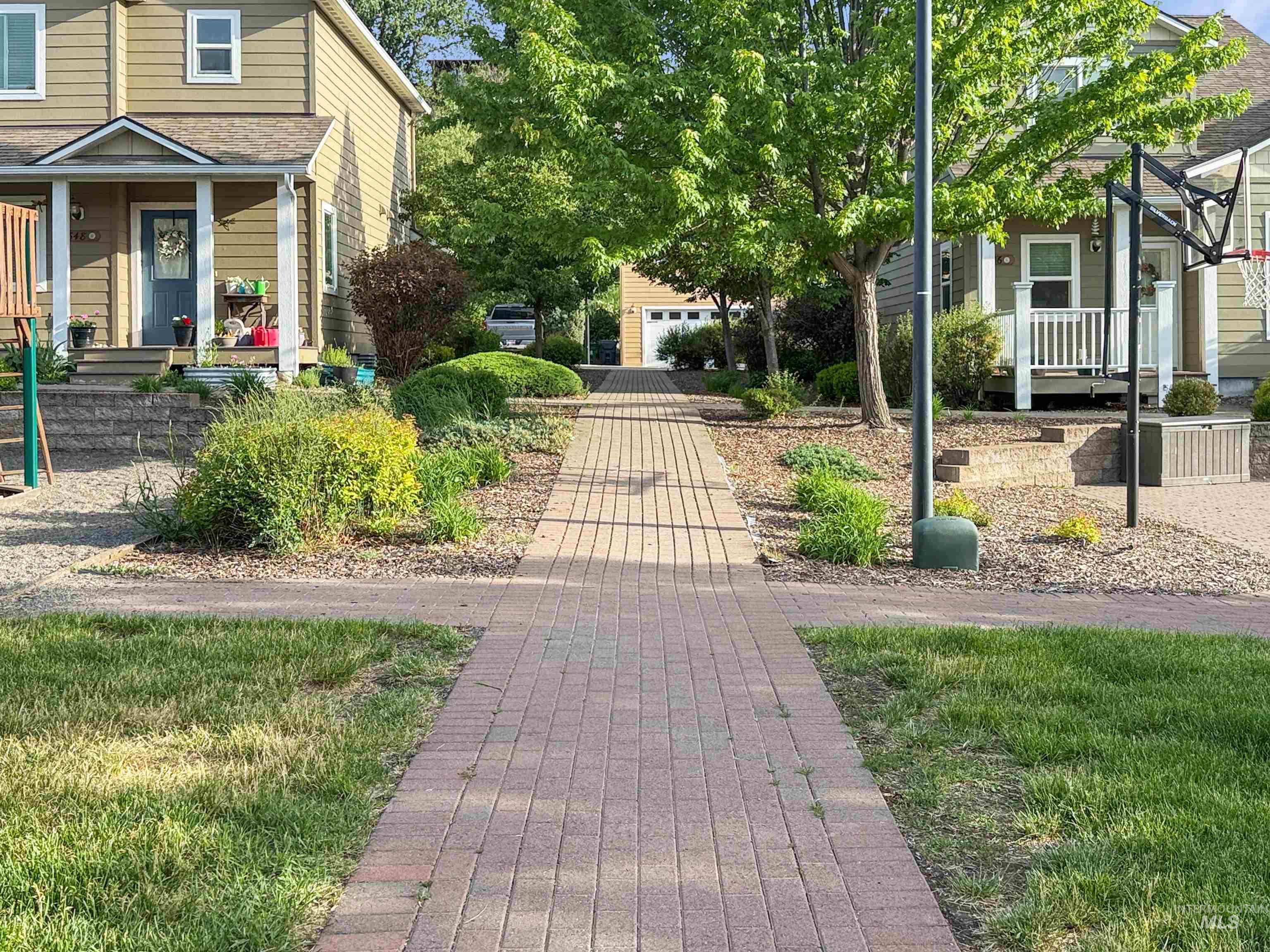 1354 Bristol Road Moscow, ID 83843 - Photo 18 of 19 Brick paver pathway with manicured shrubbery and mature trees