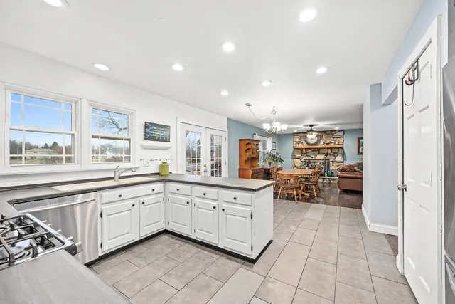 a kitchen with sink and view of living room