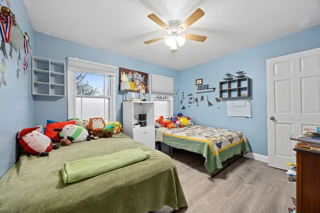 a bedroom with two beds and a chandelier