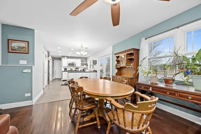 a dining room with furniture and wooden floor