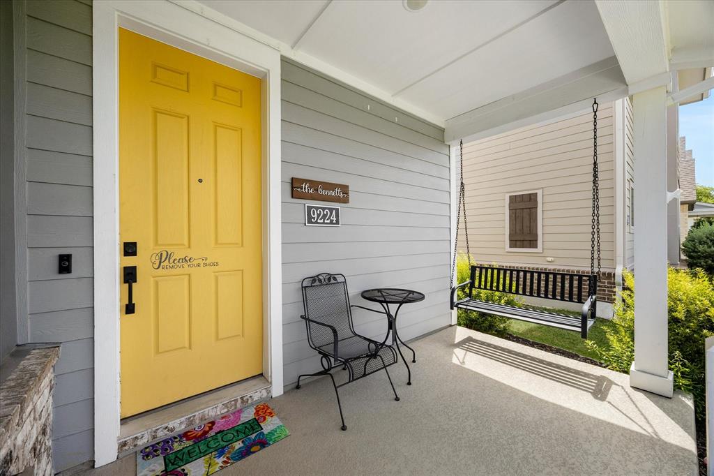 9224 Lamar Street Rowlett, TX 75089 - Photo 2 of 27 Inviting covered porch featuring grey siding and a vibrant yellow entry door