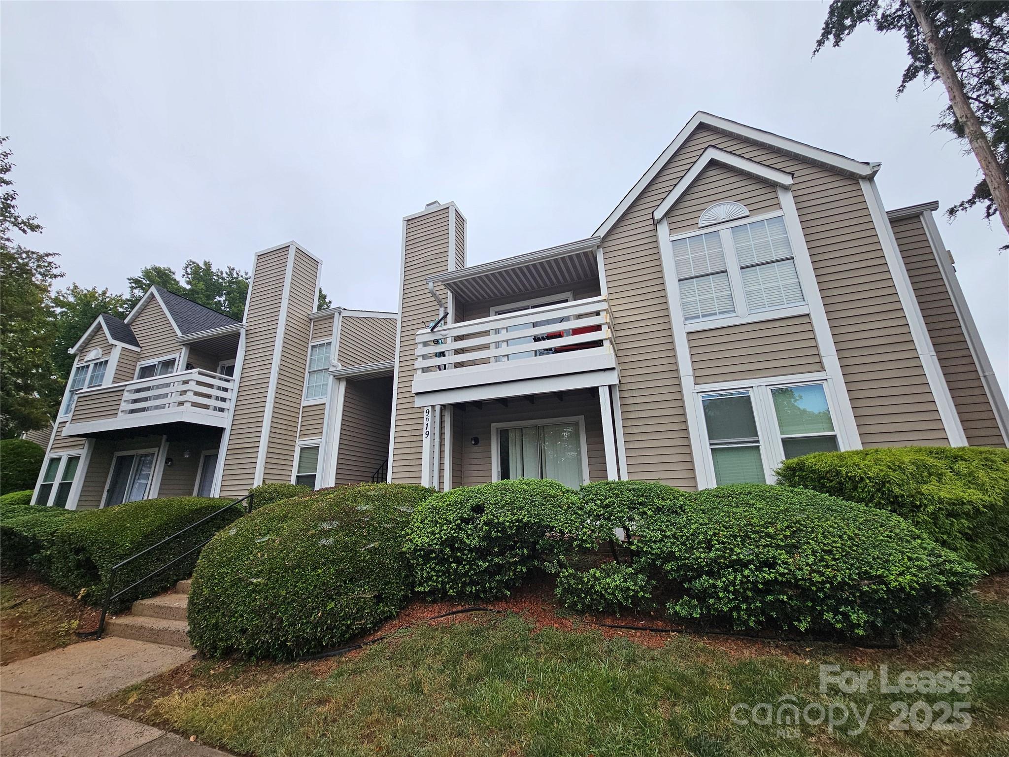 9619 Vinca Circle, Unit B Charlotte, NC 28213 - Photo 1 of 18 a front view of a house with a garden