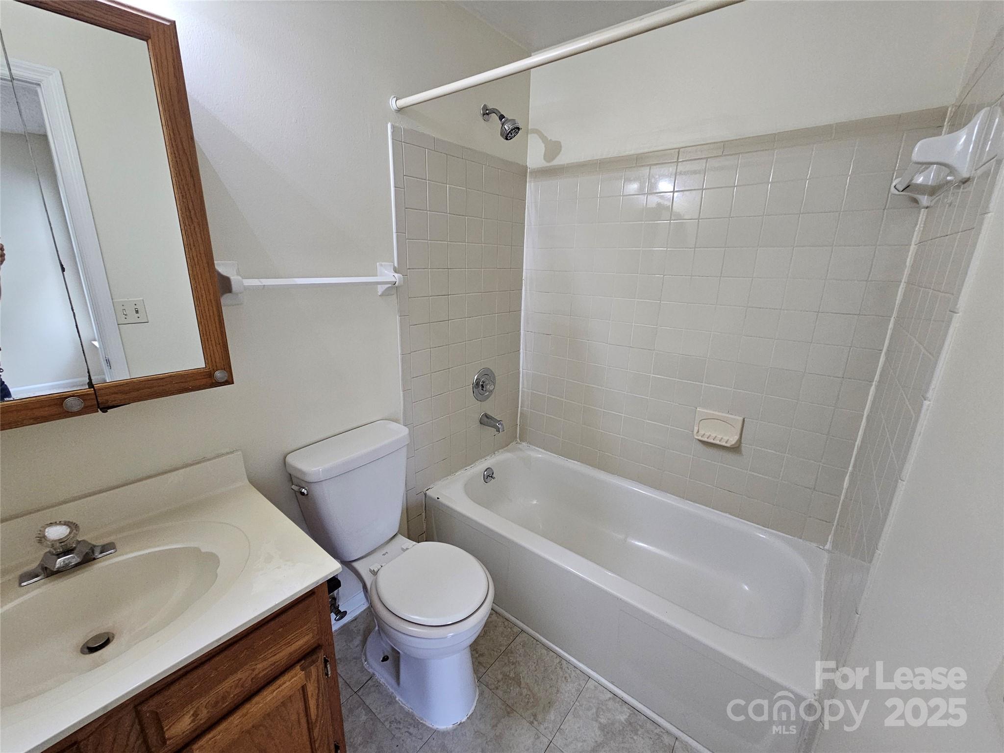 9619 Vinca Circle, Unit B Charlotte, NC 28213 - Photo 12 of 18 a bathroom with a sink a toilet and shower