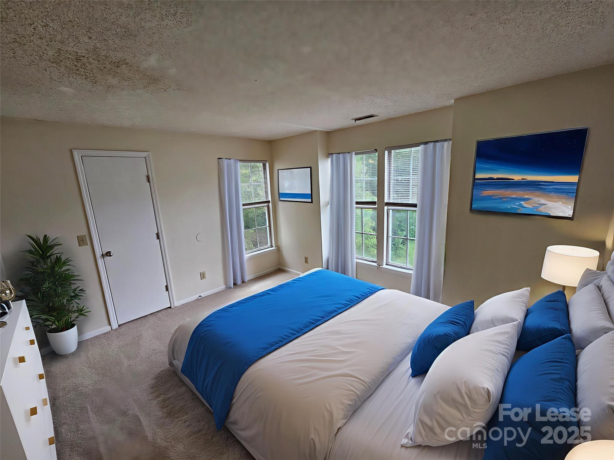 9619 Vinca Circle, Unit B Charlotte, NC 28213 - Photo 13 of 18 a bedroom with a bed and a large window