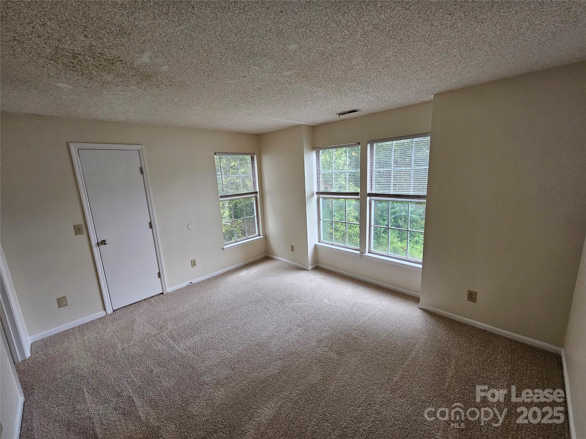 9619 Vinca Circle, Unit B Charlotte, NC 28213 - Photo 14 of 18 an empty room with windows and closet