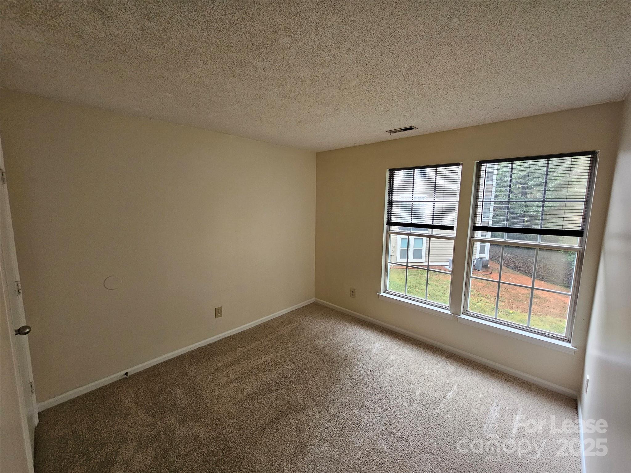 9619 Vinca Circle, Unit B Charlotte, NC 28213 - Photo 15 of 18 an empty room with a window