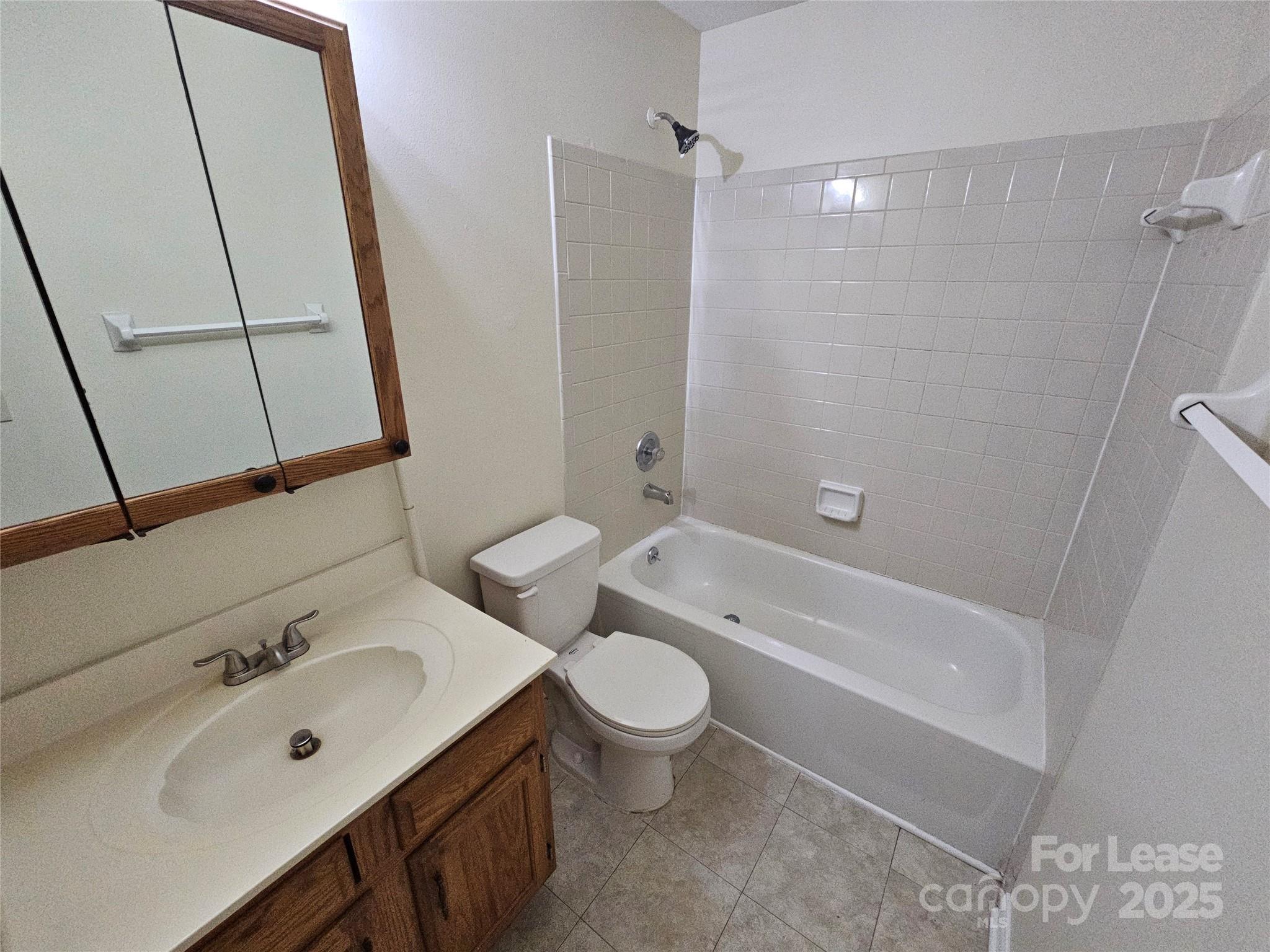 9619 Vinca Circle, Unit B Charlotte, NC 28213 - Photo 16 of 18 a bathroom with a sink a toilet and a bathtub