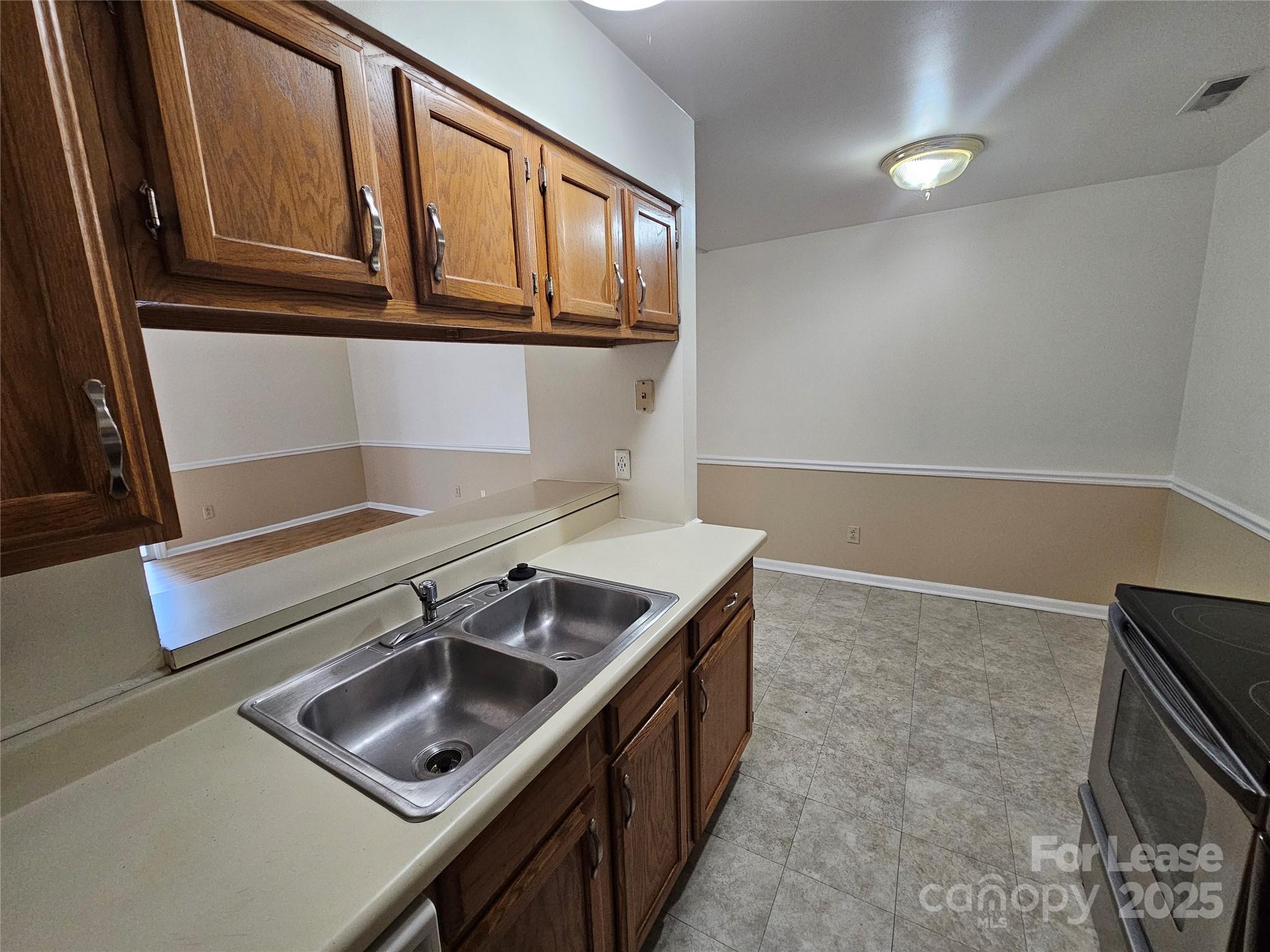 9619 Vinca Circle, Unit B Charlotte, NC 28213 - Photo 8 of 18 a kitchen that has a sink and a stove