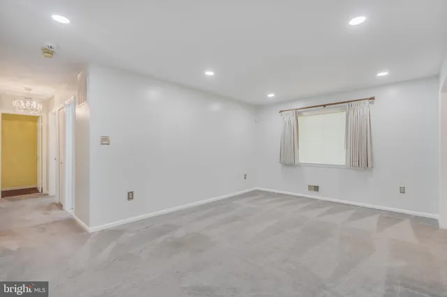 an empty room with a empty space and windows