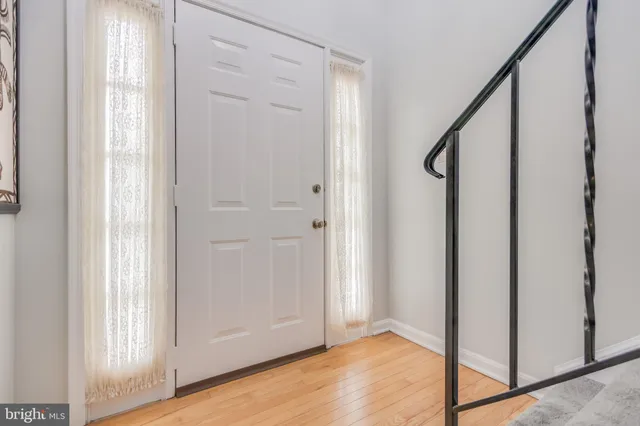 a view of an entryway with wooden floor