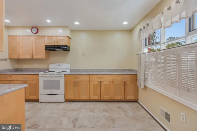 a kitchen with stainless steel appliances granite countertop a stove and a sink