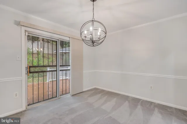 a view of wooden floor and a chandelier in a room