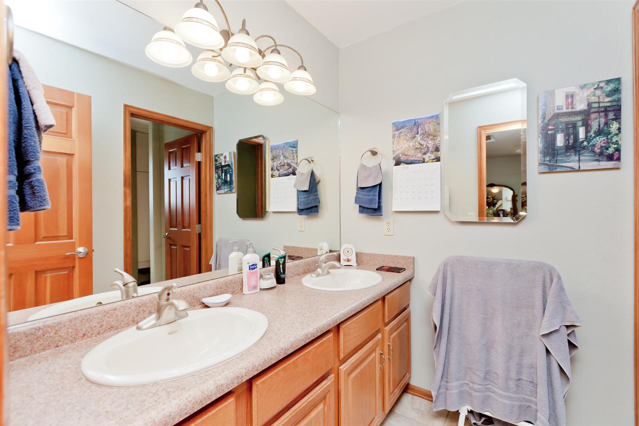 1248 21 Road Grand Junction, CO 81505 - Photo 21 of 42 a bathroom with a sink vanity and a mirror