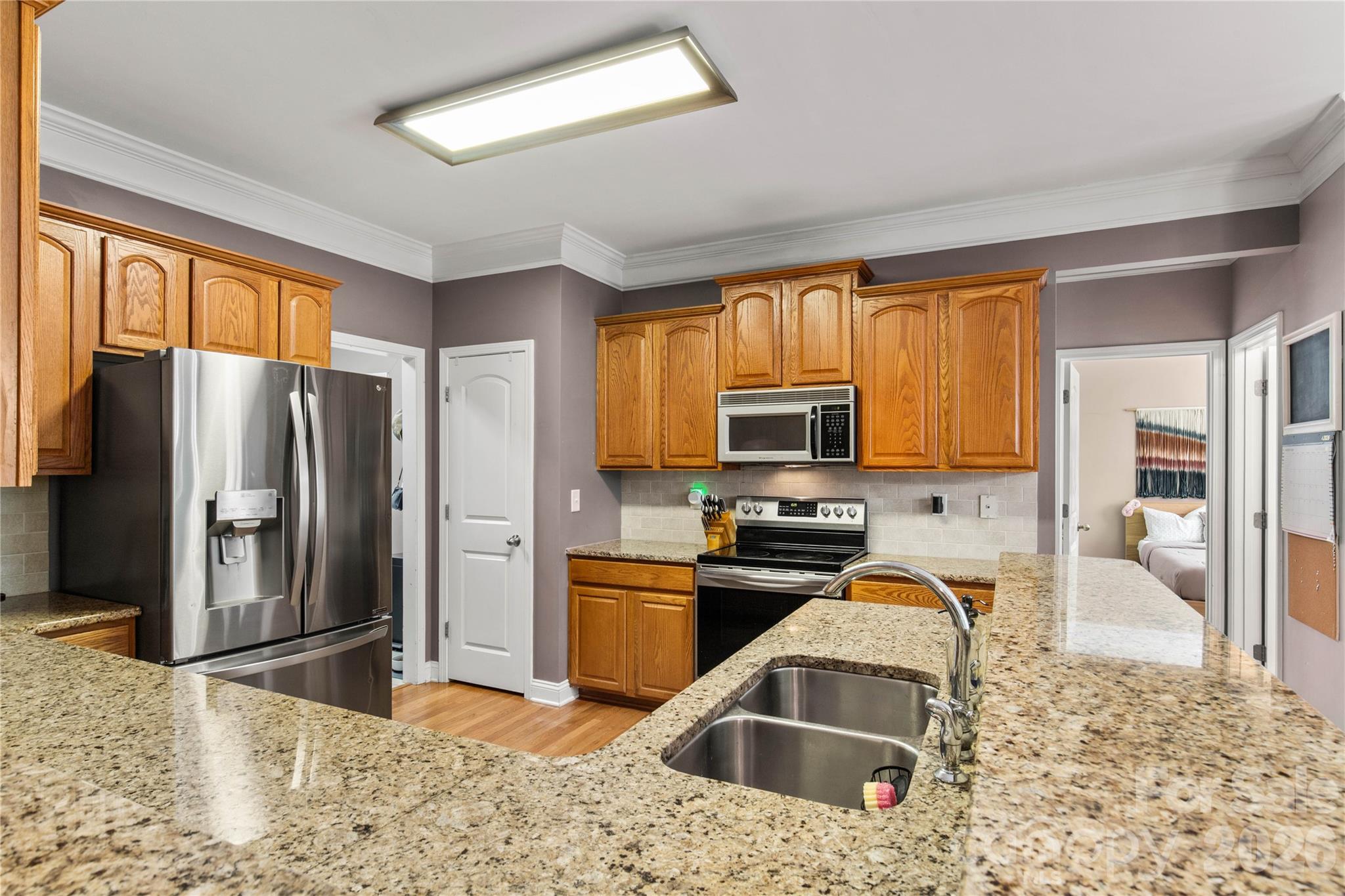 2341 Valley Meadows Drive York, SC 29745 - Photo 15 of 46 a kitchen with stainless steel appliances granite countertop a stove refrigerator and a sink