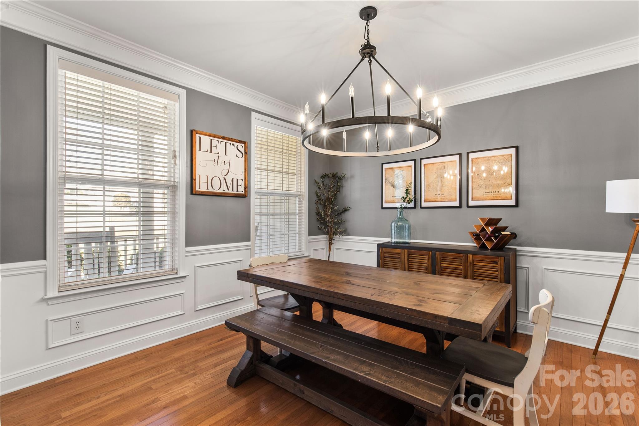 2341 Valley Meadows Drive York, SC 29745 - Photo 6 of 46 a dining room with wooden floor a chandelier a wooden table and chairs