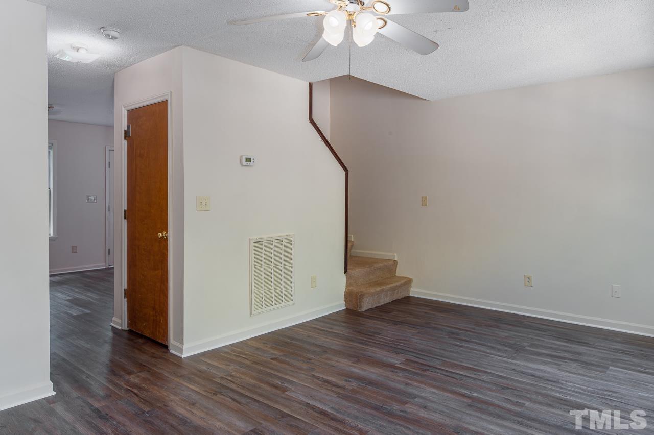 4264 Kaplan Drive Raleigh, NC 27606 - Photo 5 of 23 a view of empty room with wooden floor and fan