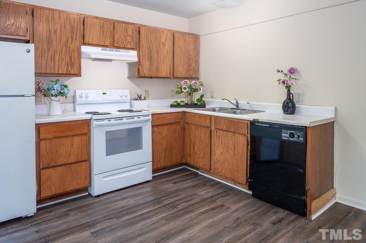 4264 Kaplan Drive Raleigh, NC 27606 - Photo 6 of 23 a kitchen with a sink cabinets and wooden floor