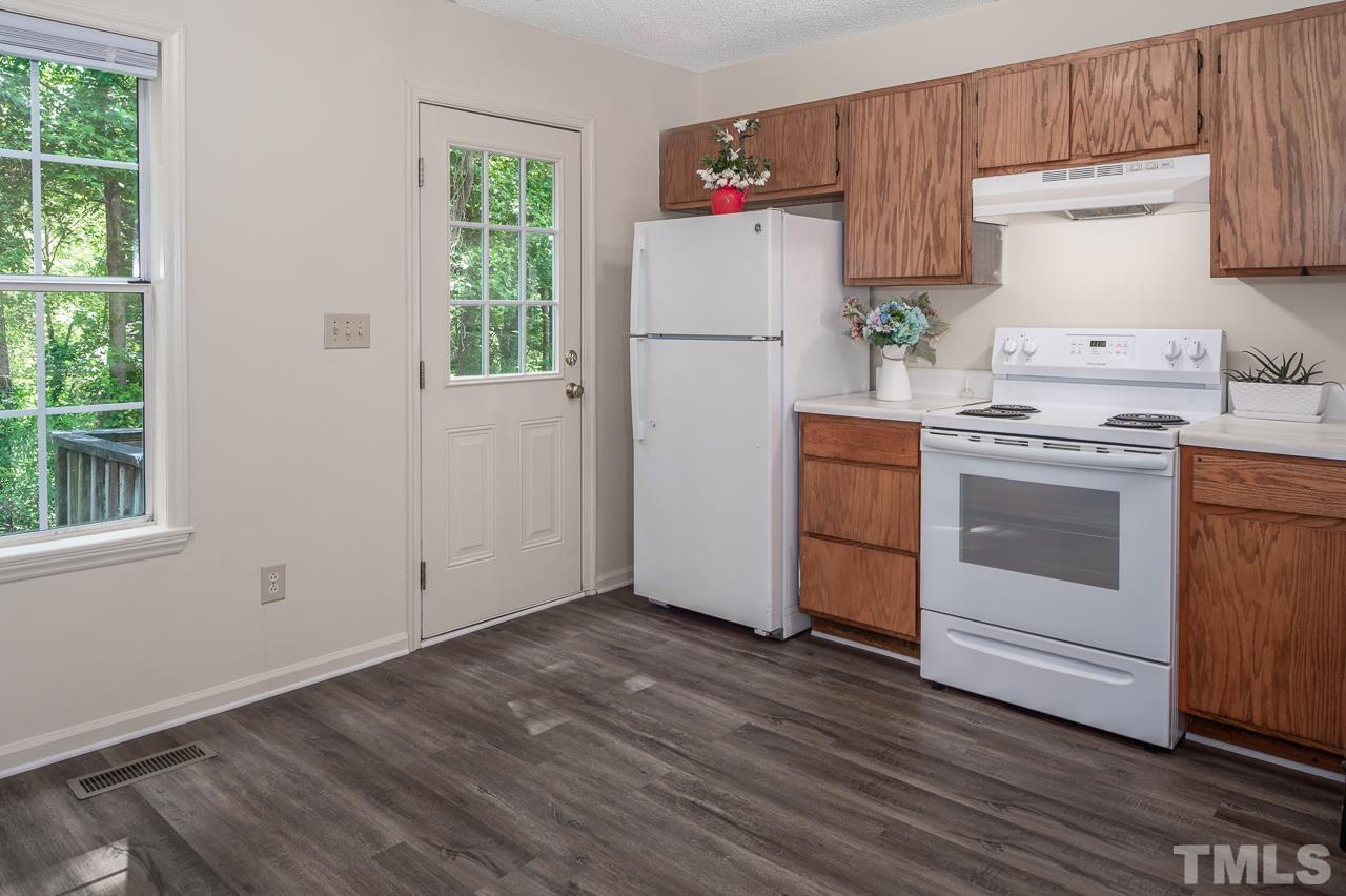 4264 Kaplan Drive Raleigh, NC 27606 - Photo 7 of 23 a kitchen with a white stove top oven and refrigerator