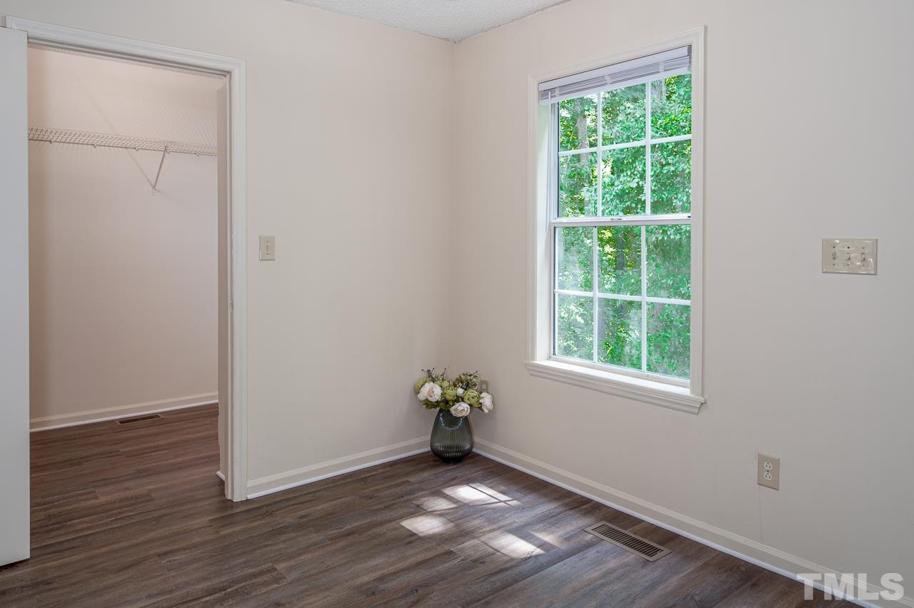 4264 Kaplan Drive Raleigh, NC 27606 - Photo 8 of 23 an empty room with wooden floor and a window
