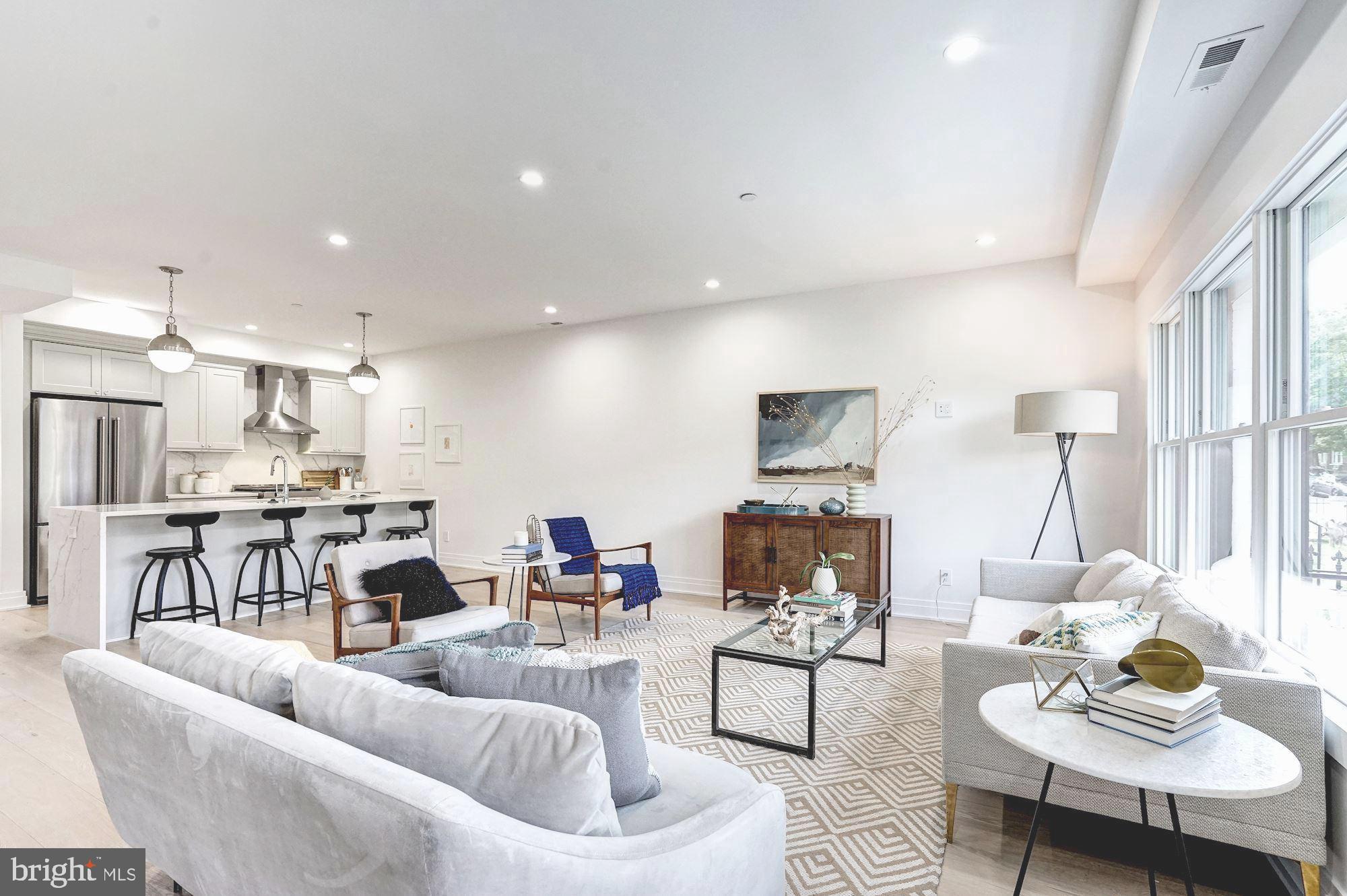 a living room with furniture kitchen and a table