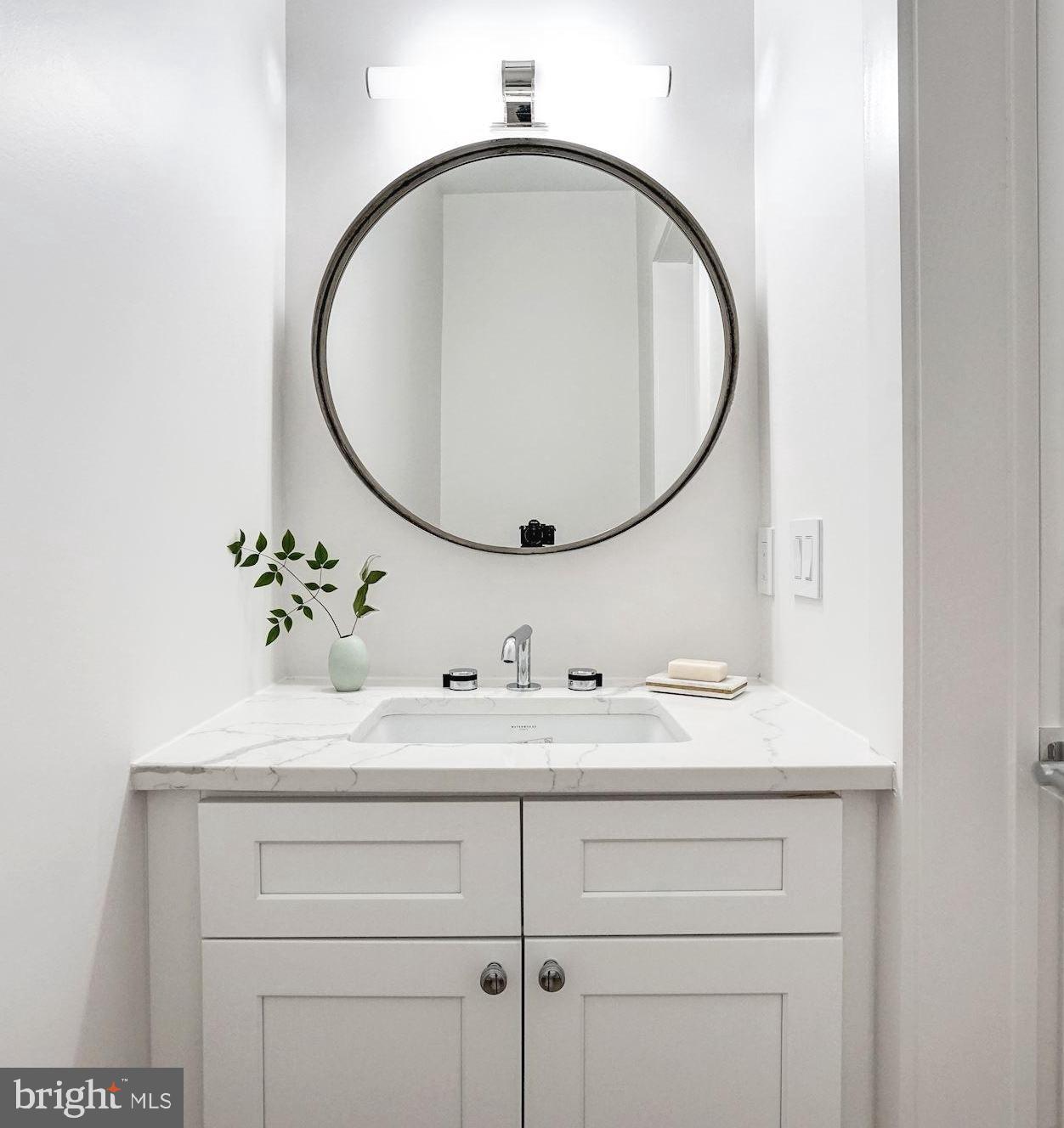 1603 Isherwood Street Northeast, Unit 2 Washington, DC 20002 - Photo 14 of 24 a bathroom with a sink and a mirror