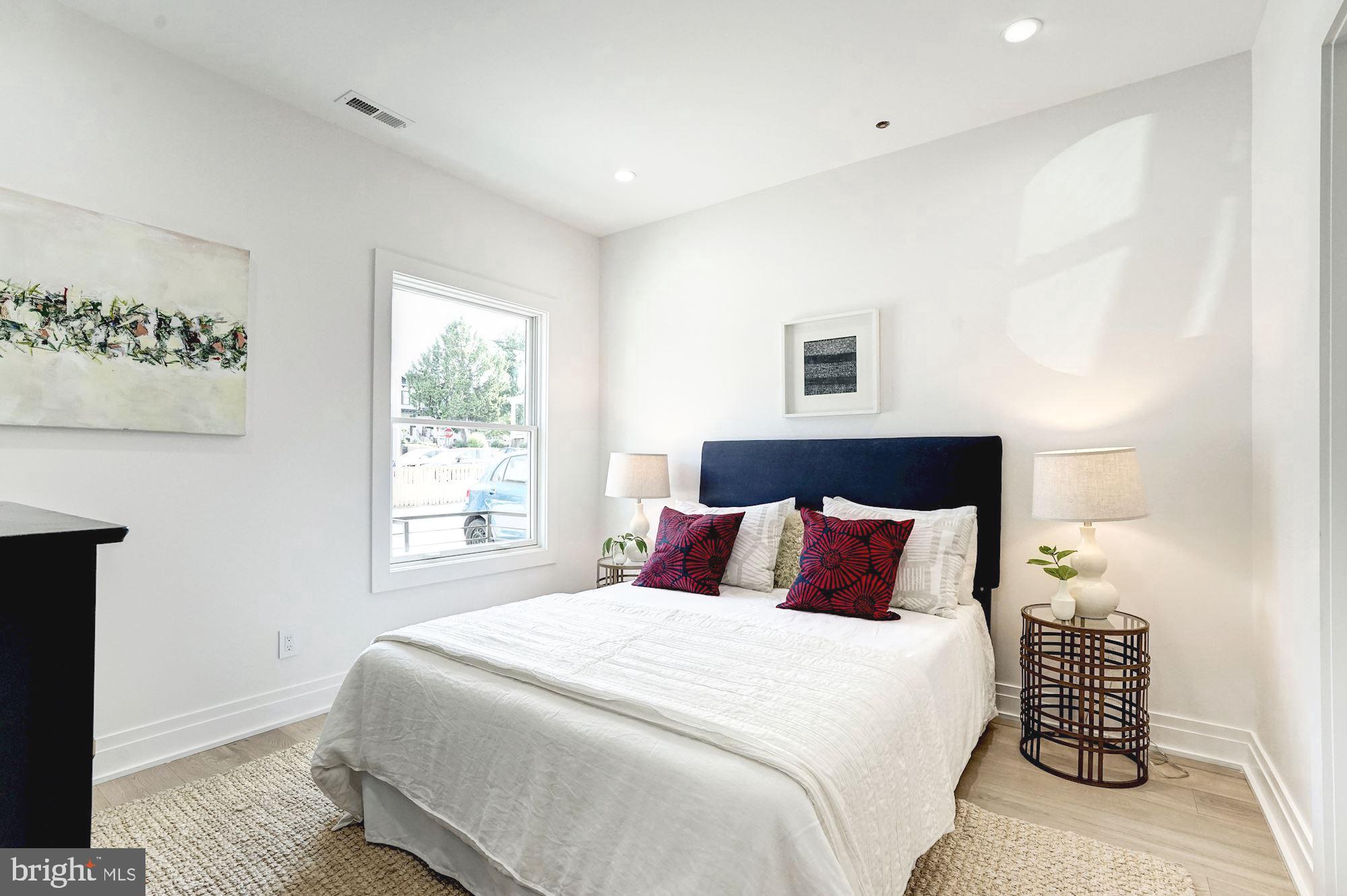 1603 Isherwood Street Northeast, Unit 2 Washington, DC 20002 - Photo 15 of 24 a bedroom with a bed and a night stand