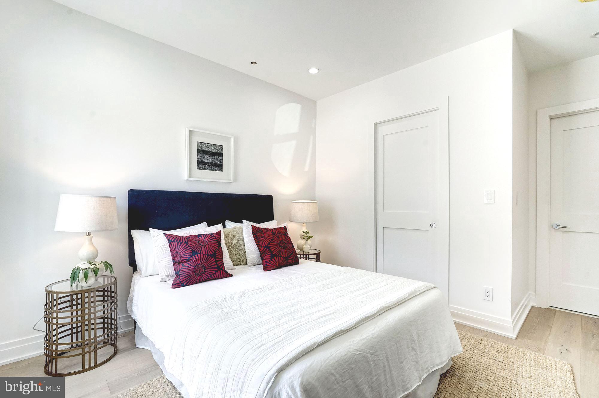 1603 Isherwood Street Northeast, Unit 2 Washington, DC 20002 - Photo 16 of 24 a bedroom with a bed and a lamp