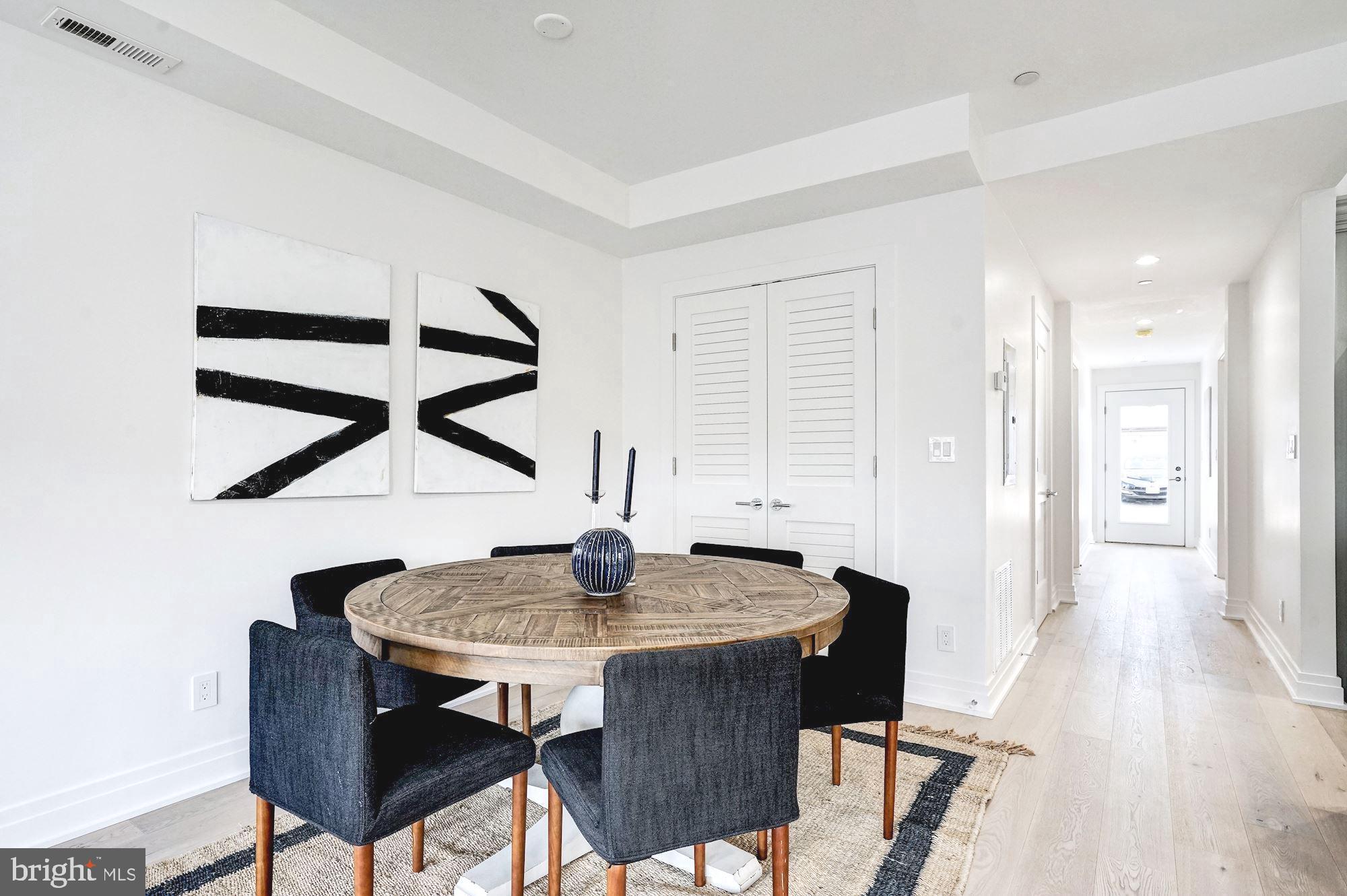 1603 Isherwood Street Northeast, Unit 2 Washington, DC 20002 - Photo 6 of 24 a view of a dining room with furniture and wooden floor