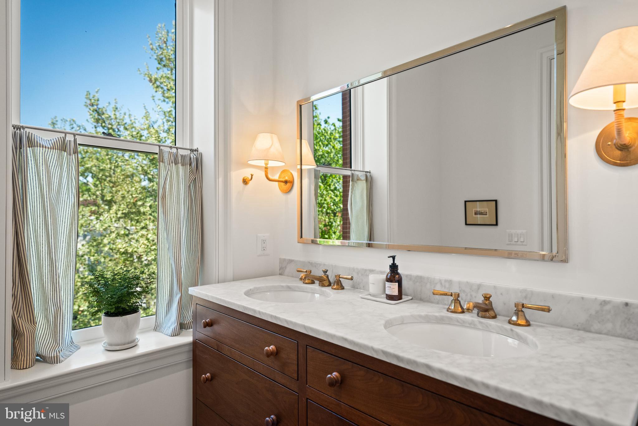 1304 S Street Northwest Washington, DC 20009 - Photo 11 of 23 a bathroom with a granite countertop sink and a mirror