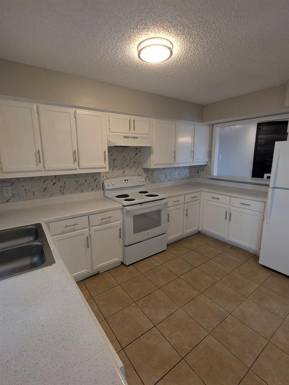 514 East Belt Line Road, Unit B13 DeSoto, TX 75115 - Photo 15 of 28 a kitchen with a sink a stove and cabinets