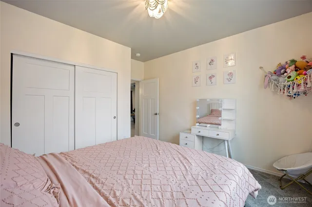 a bedroom with a bed and a chandelier