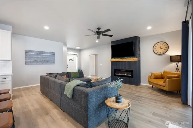 a living room with furniture a fireplace and a flat screen tv