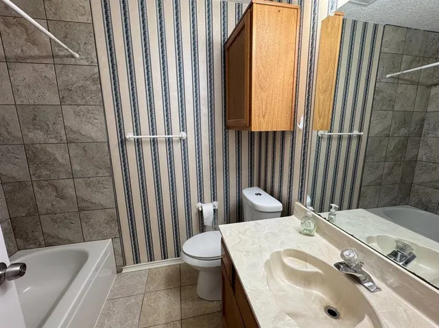 a bathroom with a sink and toilet