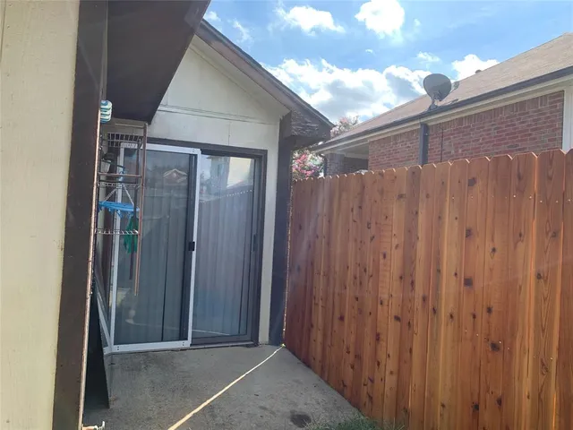a view of a house with a wooden fence