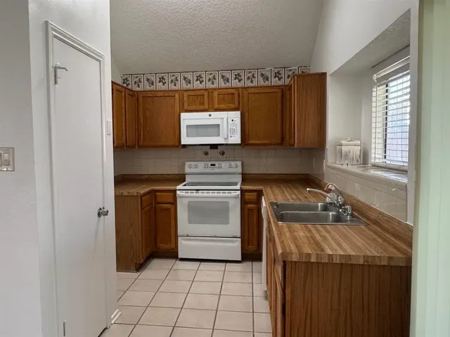 a kitchen with a stove sink and a microwave