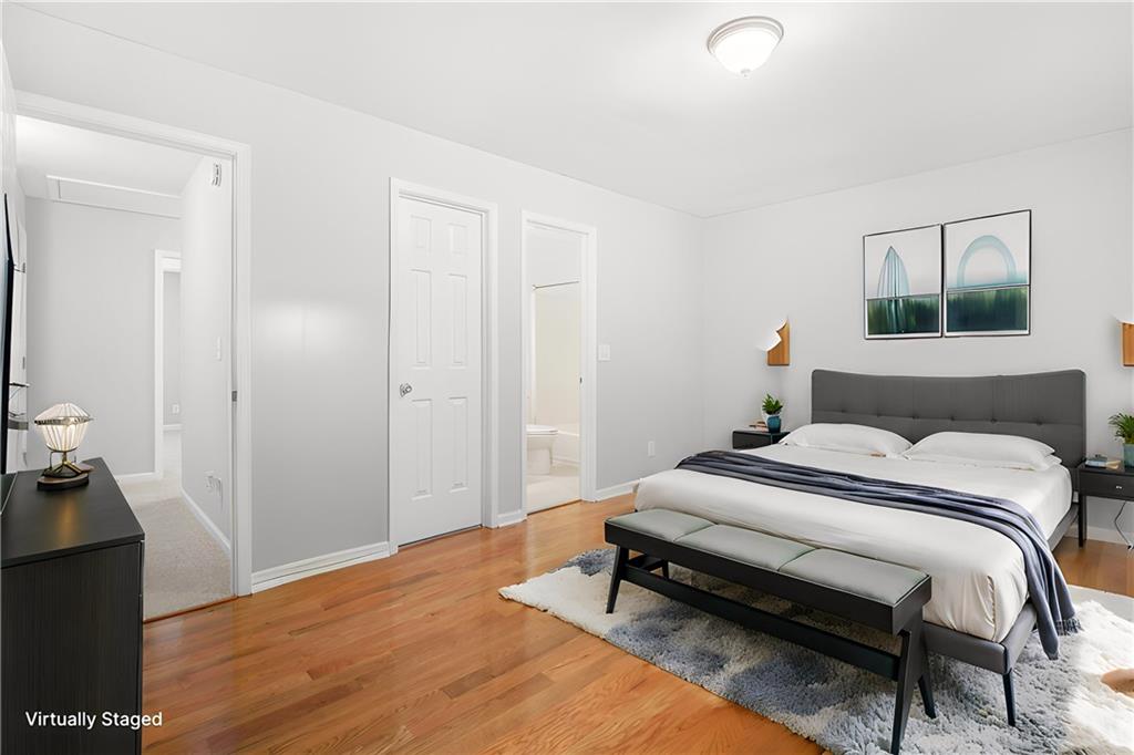 661 North Parkwood Road, Unit C Decatur, GA 30030 - Photo 3 of 14 a bedroom with a bed and a chandelier