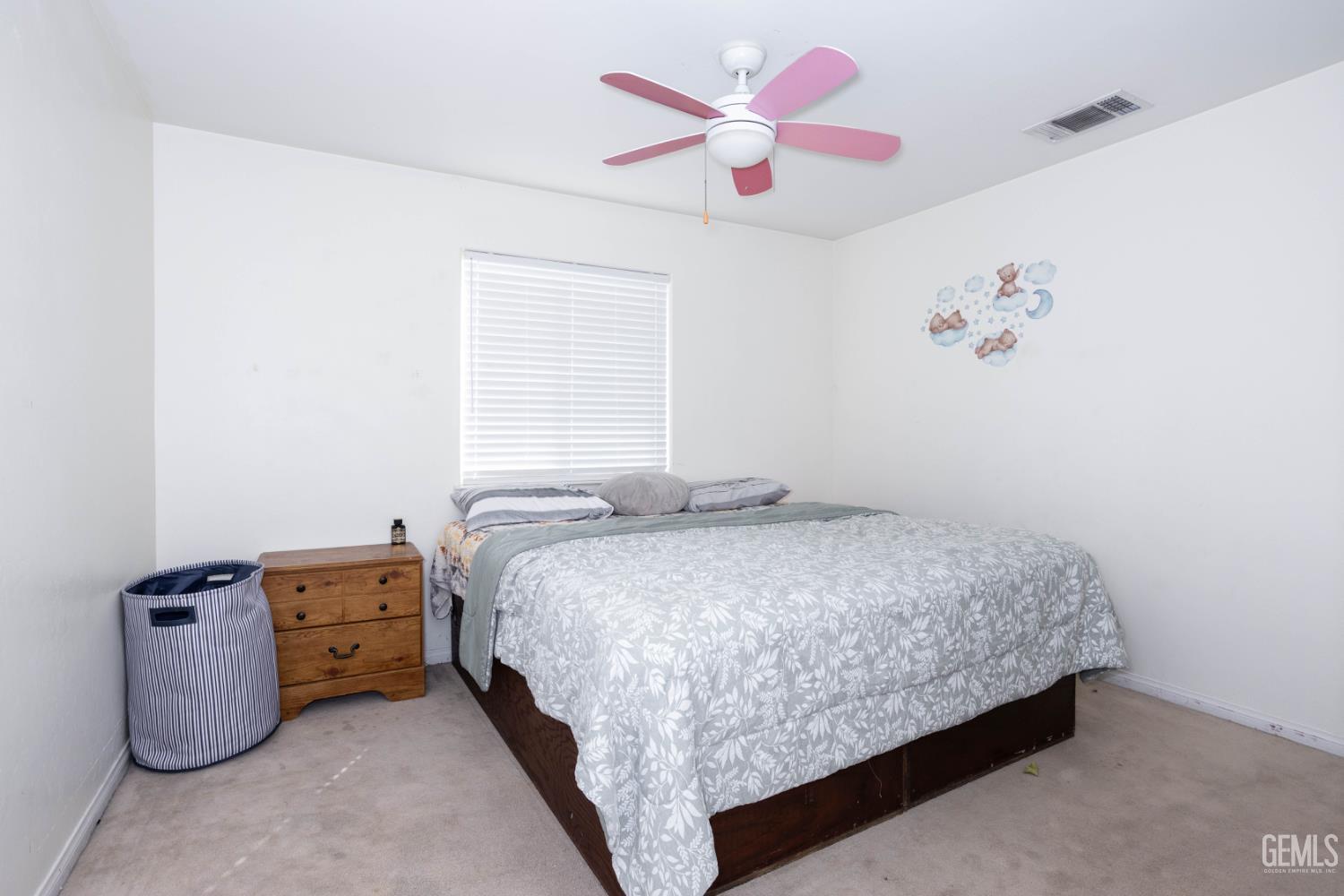 Undisclosed Address Bakersfield, CA 93313 - Photo 13 of 19 a bedroom with a bed and a chandelier