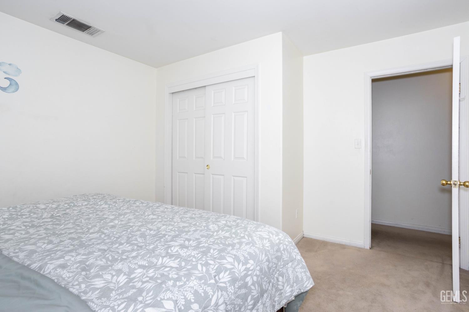 Undisclosed Address Bakersfield, CA 93313 - Photo 14 of 19 a bedroom with a bed and a rug