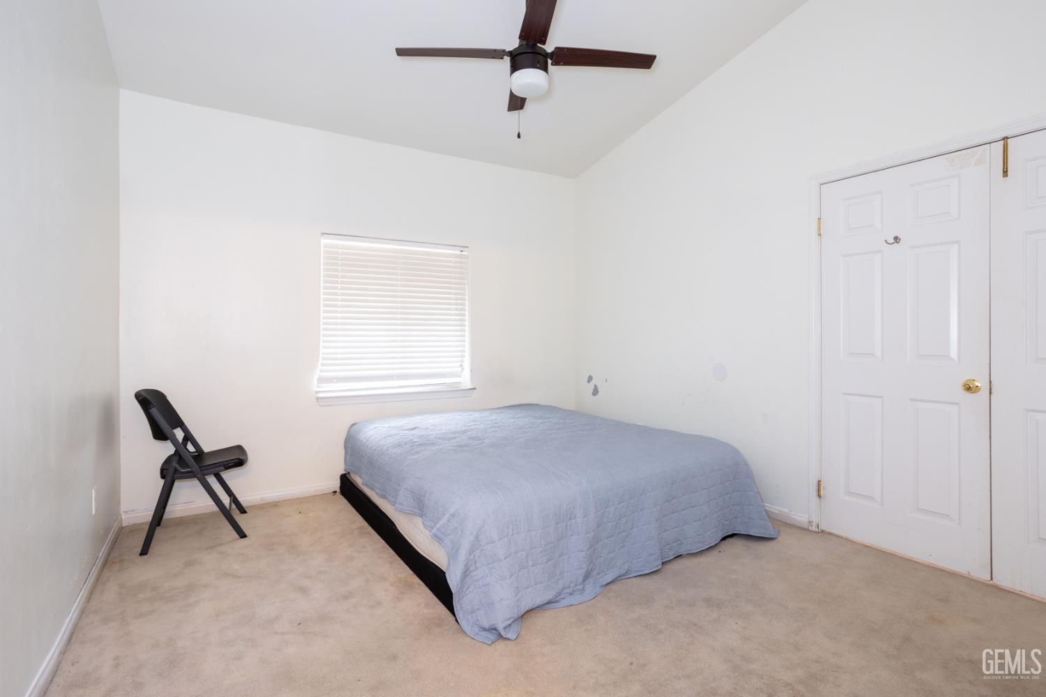 Undisclosed Address Bakersfield, CA 93313 - Photo 15 of 19 a bedroom with a bed and chair
