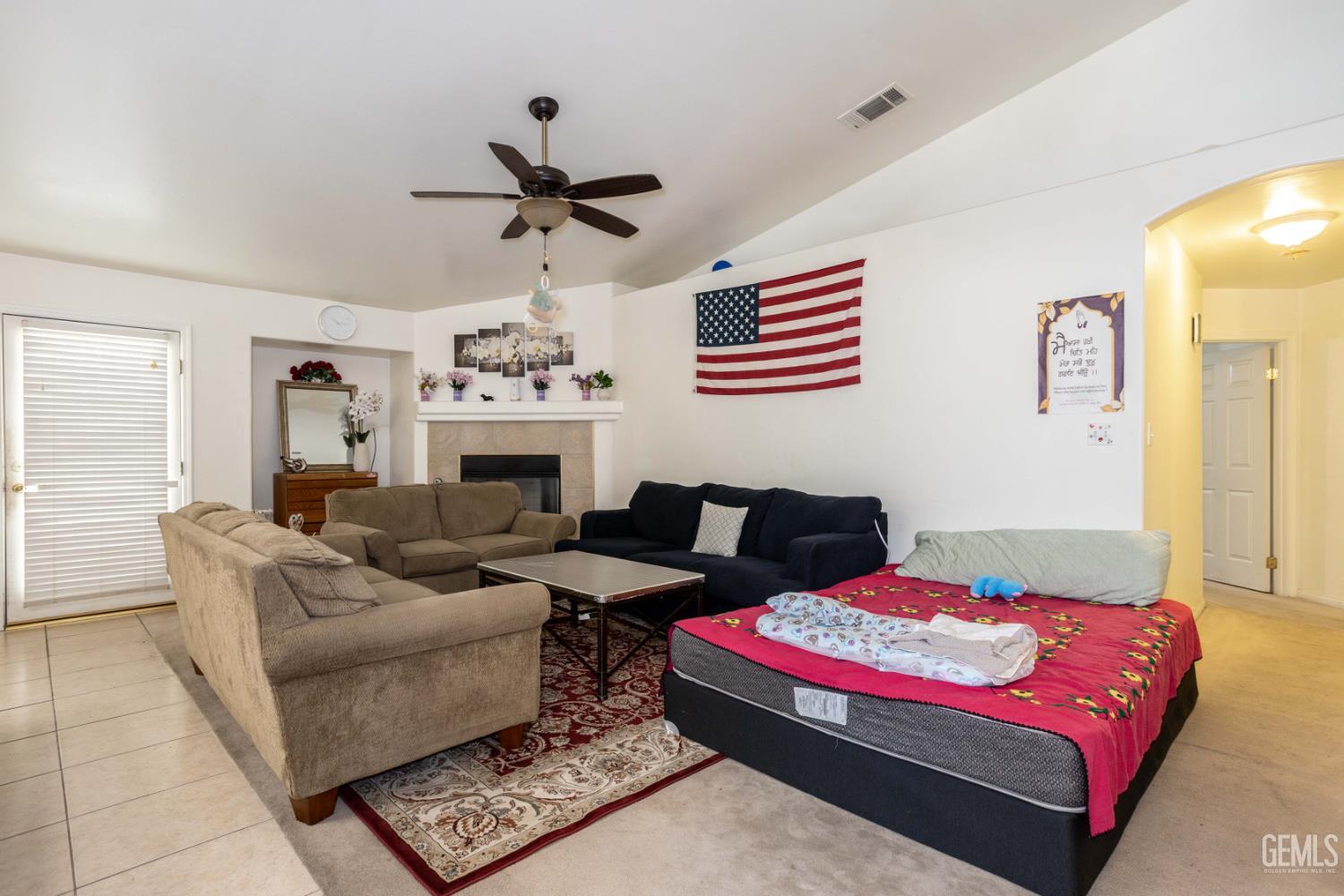 Undisclosed Address Bakersfield, CA 93313 - Photo 3 of 19 a living room with furniture a fireplace and a chandelier